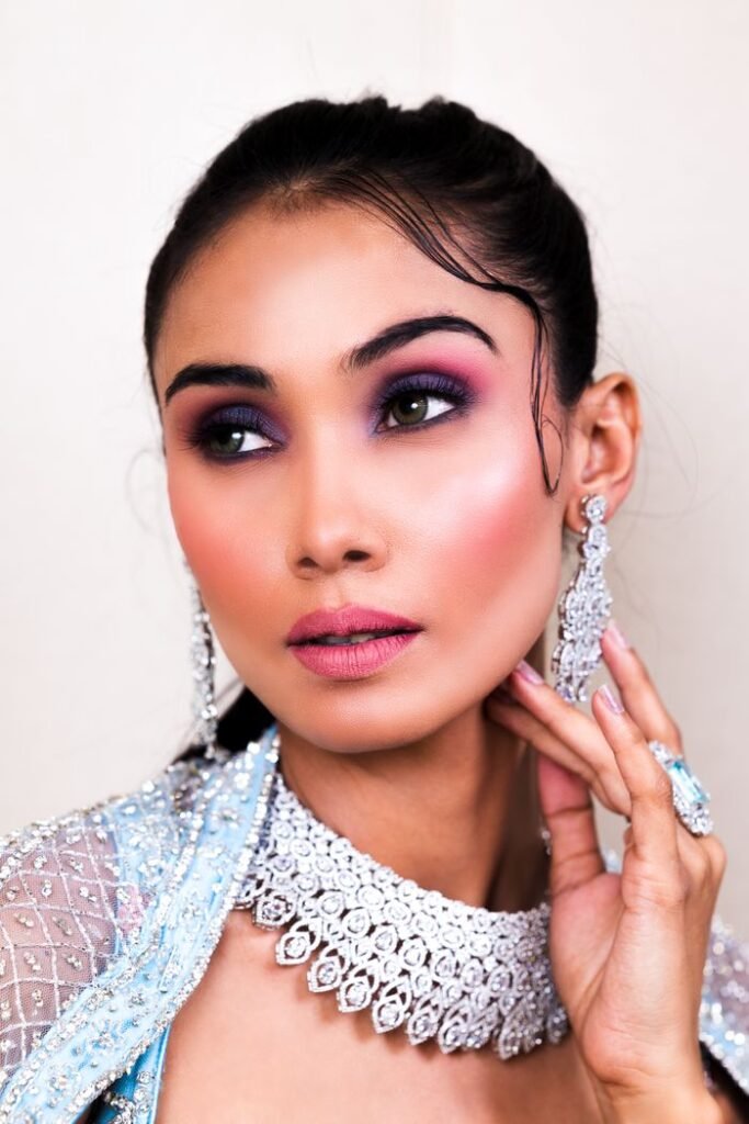 Striking portrait of a woman in elegant silver jewellery and makeup.